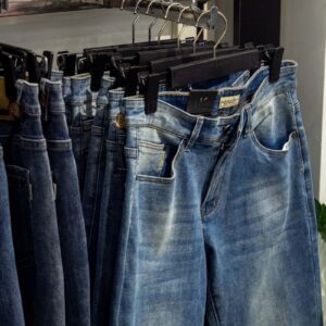 a pair of jeans hanging on a clothes rack